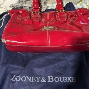 Dooney & Bourne leather bag. Some tears the bottom edges. Gently used.
